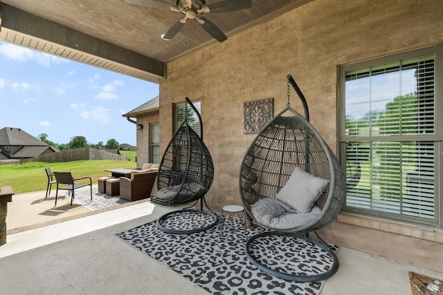 view of patio with an outdoor living space, a ceiling fan, and fence