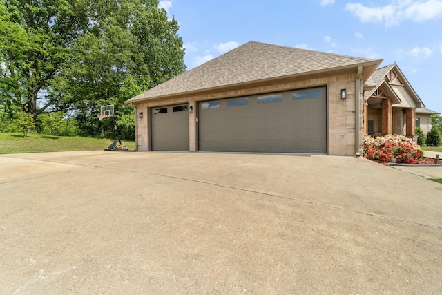 view of home's exterior featuring brick siding, driveway, and an attached garage