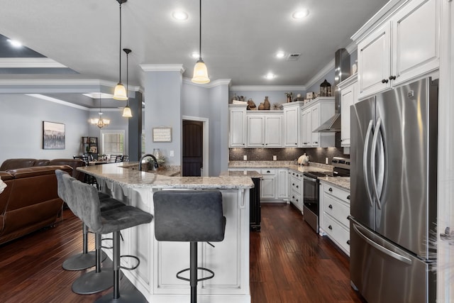 kitchen with white cabinetry, appliances with stainless steel finishes, a breakfast bar, open floor plan, and light stone countertops
