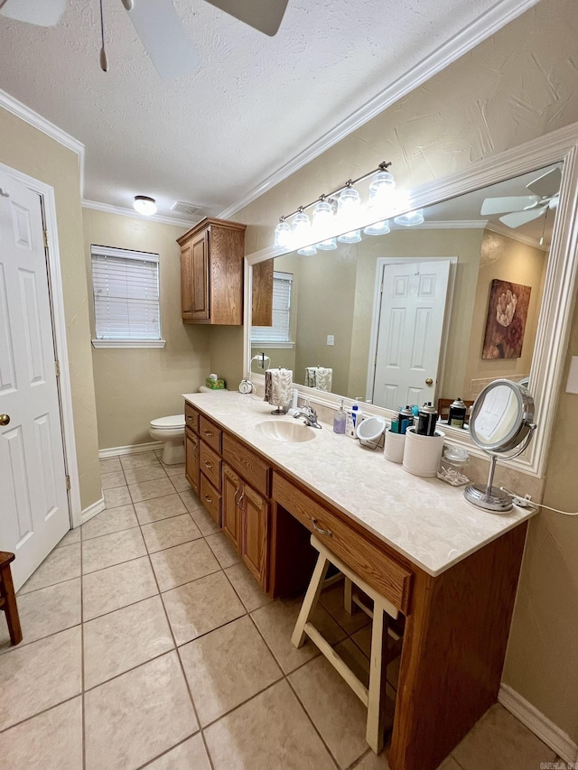 bathroom featuring vanity, tile patterned floors, crown molding, toilet, and a ceiling fan