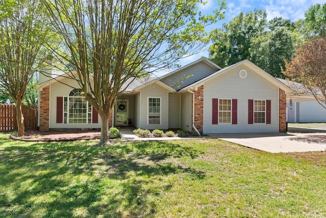 ranch-style house featuring a front yard, fence, and brick siding