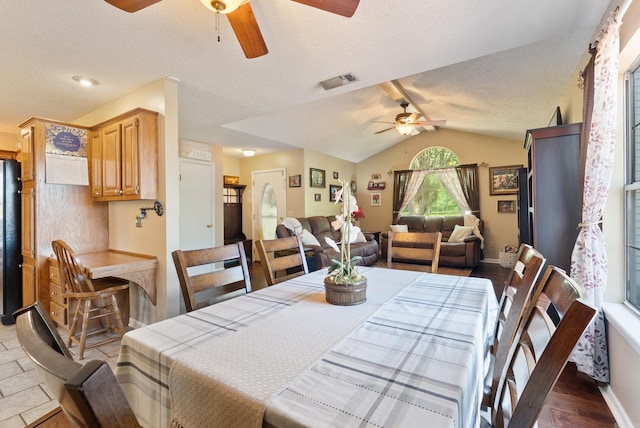 dining room with ceiling fan, baseboards, vaulted ceiling, and visible vents