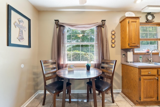 dining space featuring light tile patterned floors and baseboards