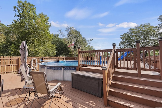 wooden terrace with fence and a fenced in pool