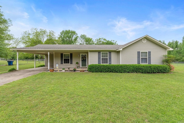 ranch-style home with a front yard, covered porch, a carport, concrete driveway, and fence