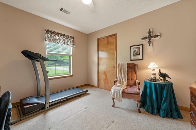 interior space with baseboards, visible vents, ceiling fan, and carpet flooring
