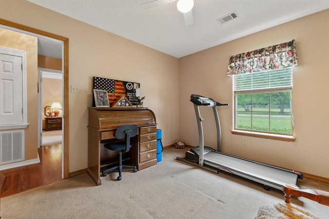 exercise area with visible vents, a ceiling fan, carpet flooring, and baseboards