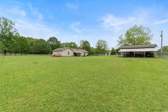 view of yard featuring fence and an outdoor structure