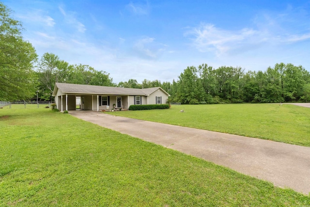 ranch-style home with a front lawn, driveway, an attached carport, and fence
