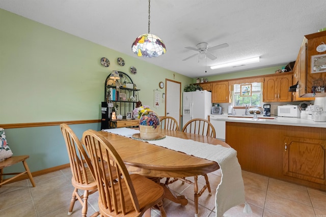 dining room featuring a ceiling fan and light tile patterned flooring