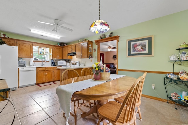 dining area with light tile patterned flooring and a ceiling fan