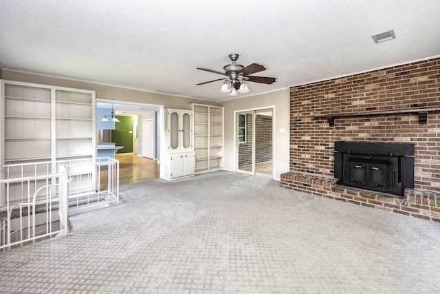 unfurnished living room with a ceiling fan, visible vents, carpet floors, and a textured ceiling