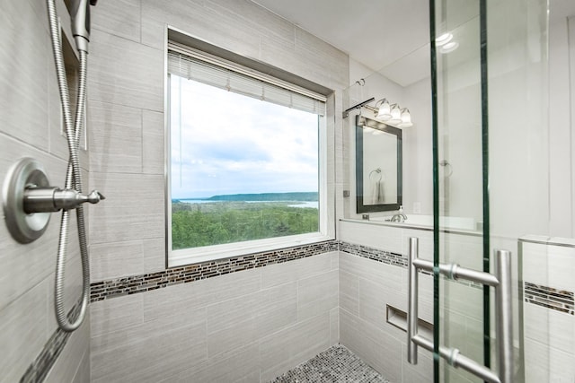 full bath featuring a shower stall and tile walls