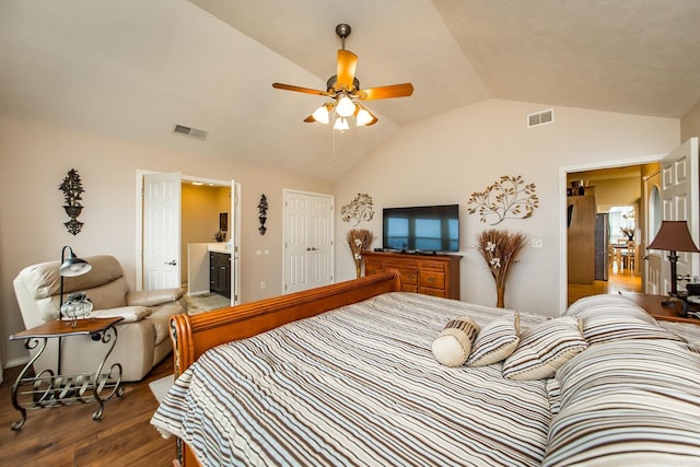 bedroom featuring connected bathroom, visible vents, vaulted ceiling, and wood finished floors