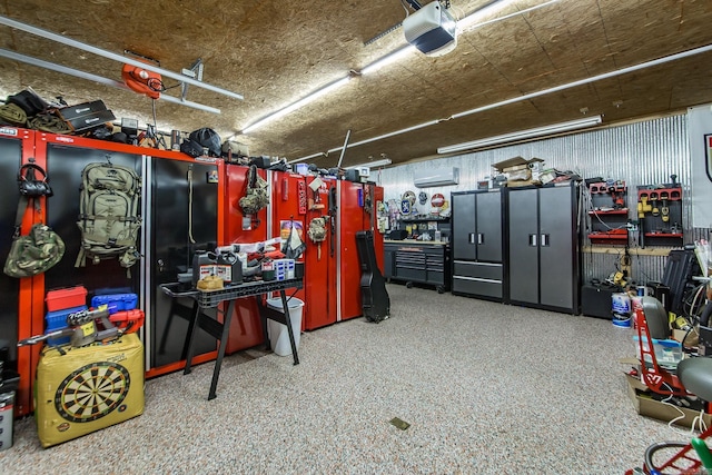 garage featuring a workshop area, a wall mounted AC, and a garage door opener