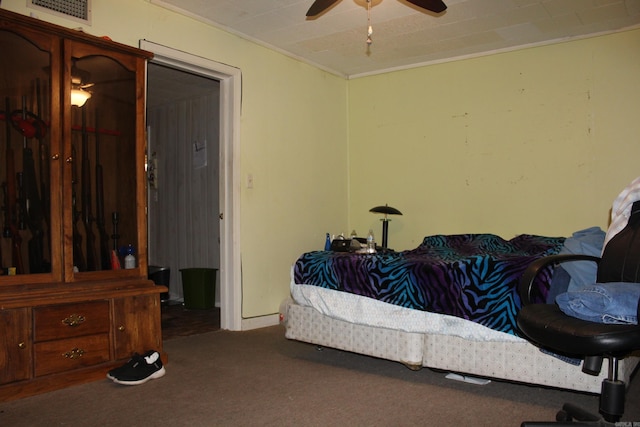 carpeted bedroom featuring visible vents and a ceiling fan