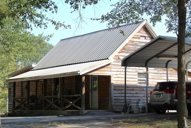 exterior space with metal roof and a carport