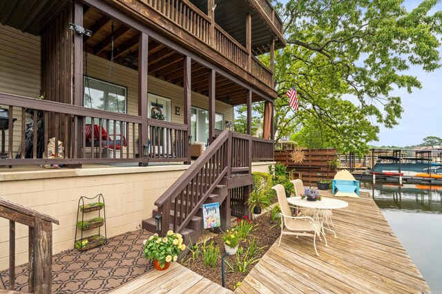 wooden terrace with stairway and a boat dock