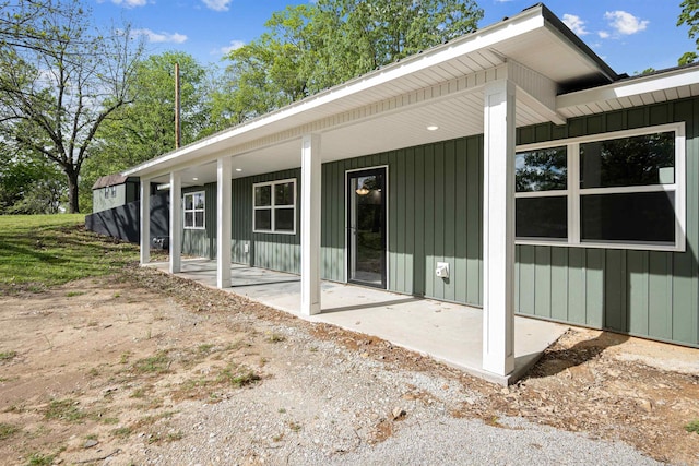 back of house with a patio and board and batten siding