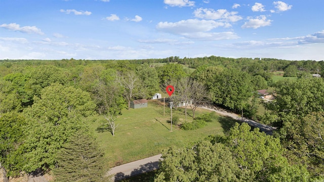 birds eye view of property with a view of trees
