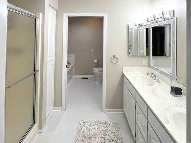 full bathroom with double vanity, a sink, and a shower stall
