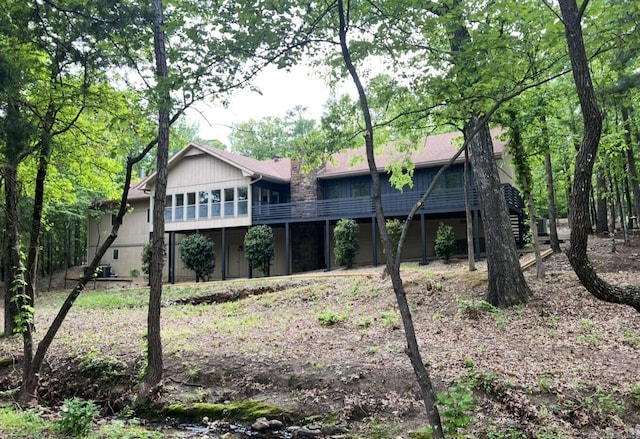 back of property featuring stairs