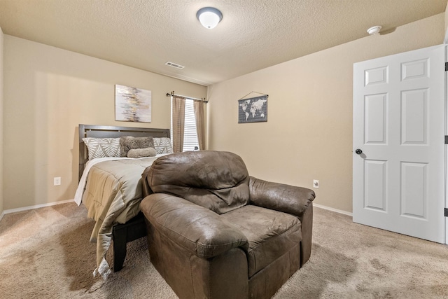 bedroom with a textured ceiling, visible vents, light carpet, and baseboards