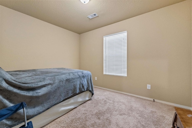 bedroom featuring carpet, visible vents, multiple windows, and baseboards