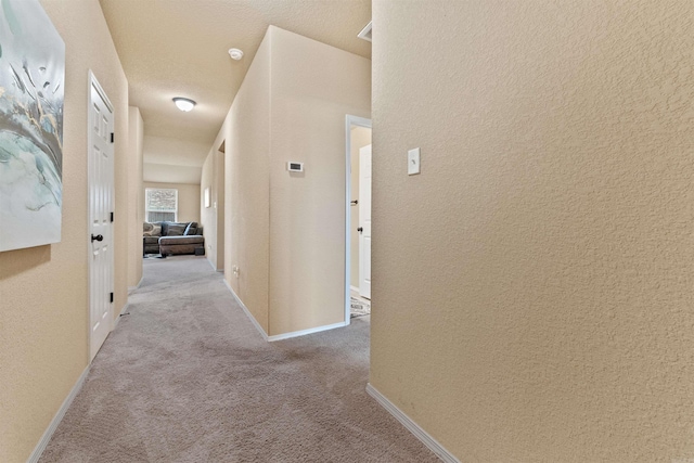 corridor with carpet flooring and baseboards