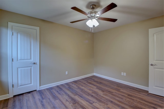 spare room with a ceiling fan, wood finished floors, and baseboards