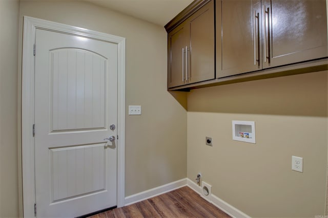 washroom featuring hookup for an electric dryer, washer hookup, dark wood-style floors, baseboards, and cabinet space