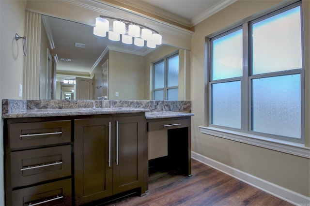 bathroom featuring a wealth of natural light, wood finished floors, ornamental molding, and baseboards