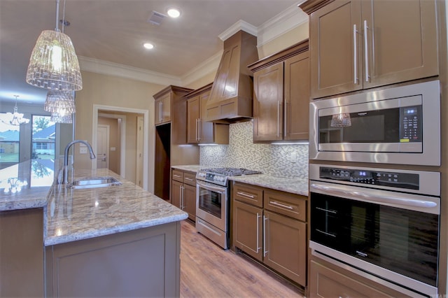 kitchen featuring a sink, stainless steel appliances, ornamental molding, tasteful backsplash, and premium range hood
