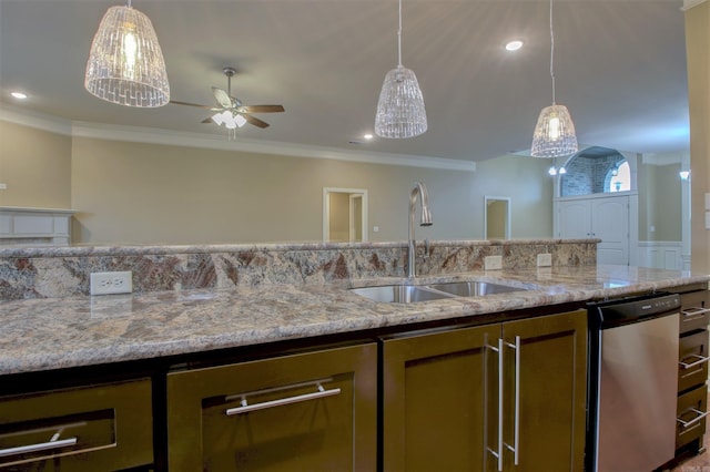kitchen featuring light stone countertops, hanging light fixtures, and a sink