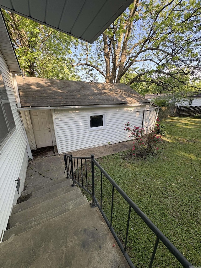 exterior space with a lawn and fence