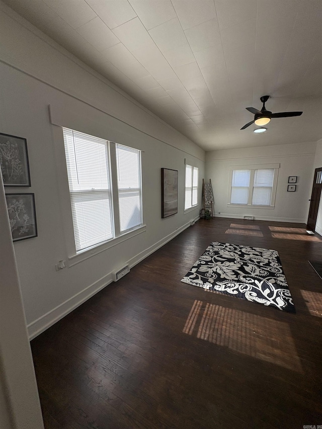 living room with a ceiling fan, dark wood finished floors, and baseboards