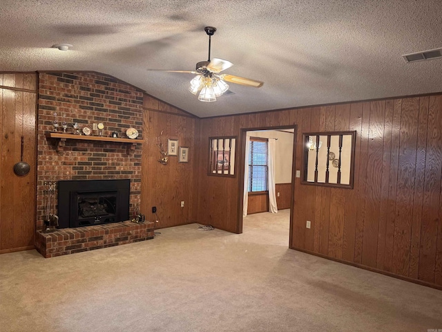 1721 Azalea Hills Rd, White Hall, AR 71602 - unfurnished living room featuring ceiling fan, carpet, vaulted ceiling, wood walls, and a fireplace