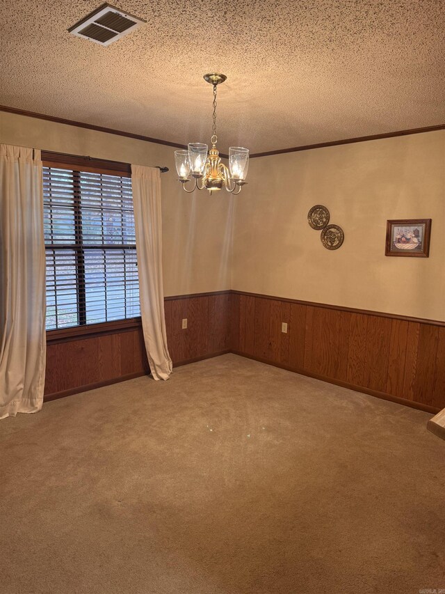 1721 Azalea Hills Rd, White Hall, AR 71602 - empty room featuring a chandelier, a textured ceiling, crown molding, a wainscoted wall, and wood walls