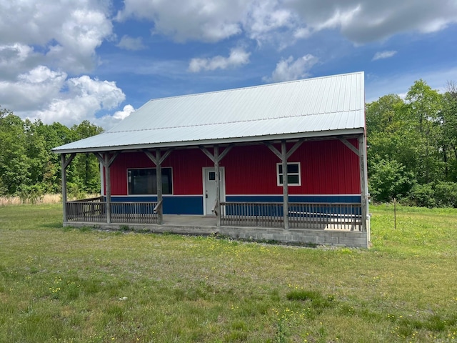 rustic home with a front yard and metal roof