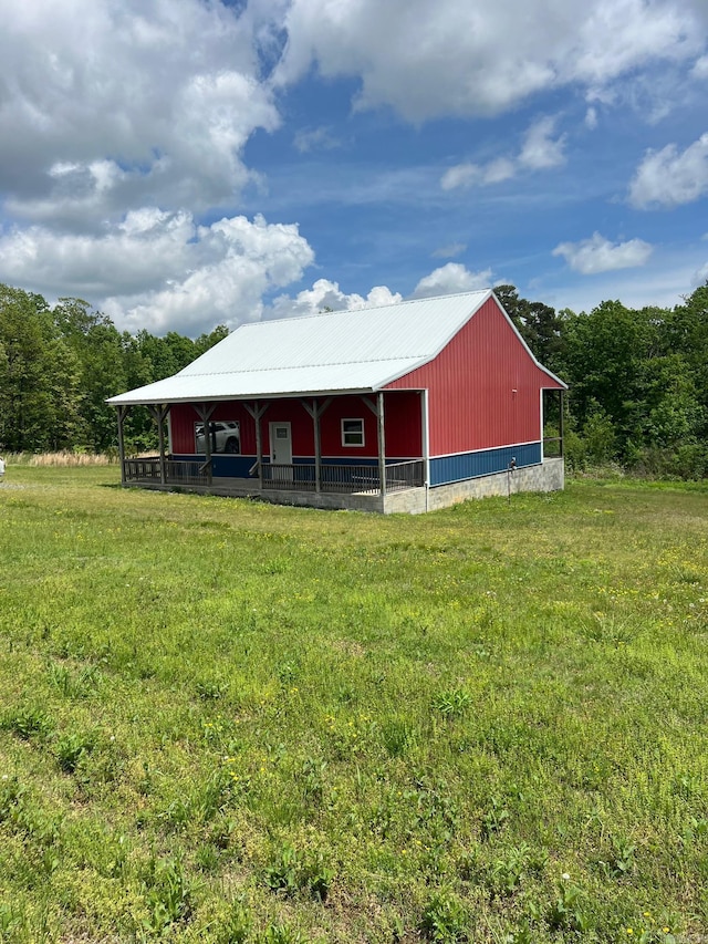 view of pole building with a yard