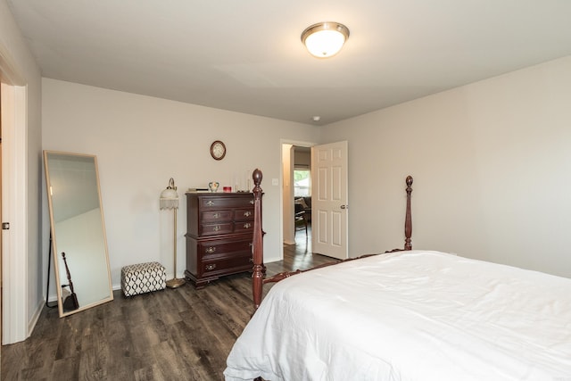bedroom featuring dark wood-style floors and baseboards