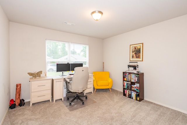 office space with visible vents, baseboards, and light carpet