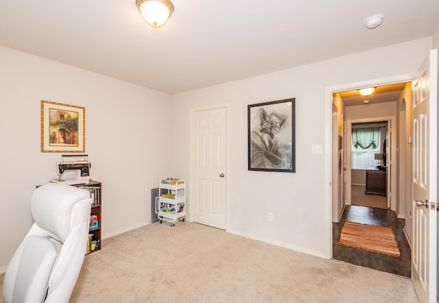 carpeted home office featuring baseboards