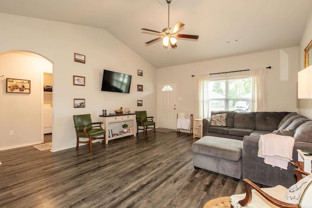 living area with arched walkways, dark wood-style floors, visible vents, a ceiling fan, and high vaulted ceiling