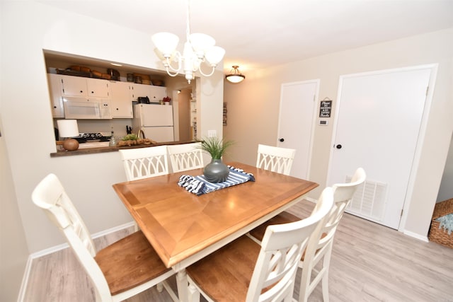 135 Hillview Dr Unit 109, Fairfield Bay, AR 72088 - dining space with visible vents, baseboards, a chandelier, and light wood-style floors