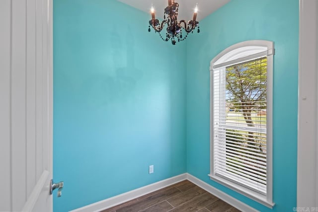 2360 Lakeshore Ln, Cabot, AR 72023 - spare room with a notable chandelier, dark wood-style flooring, and baseboards