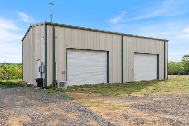detached garage featuring ac unit