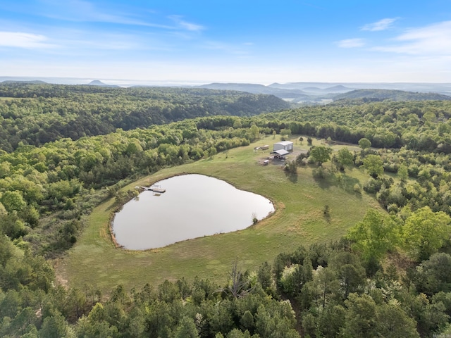 aerial view featuring a water and mountain view and a wooded view