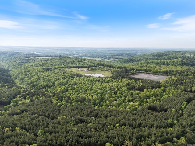 drone / aerial view featuring a wooded view
