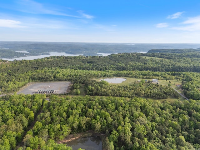 aerial view featuring a water view and a forest view